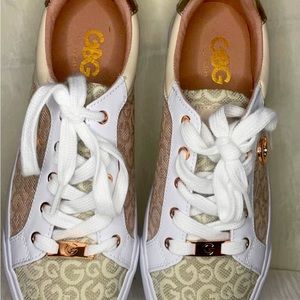 Brand new brand shoes.White, brown and a metallic color on the heal